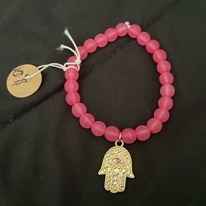 Pink beaded bracelet with hand charm